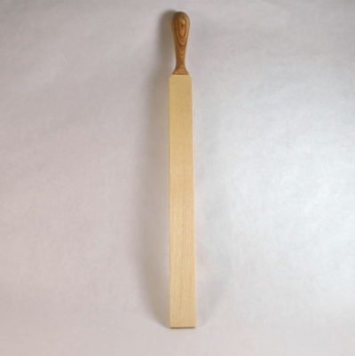 Stinger Spanking paddle with olive ash handle stood